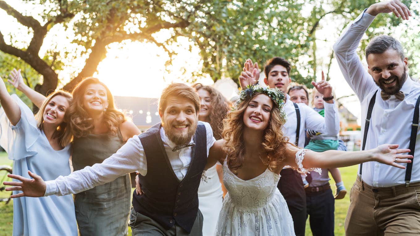 Bride and groom posed at reception with guests