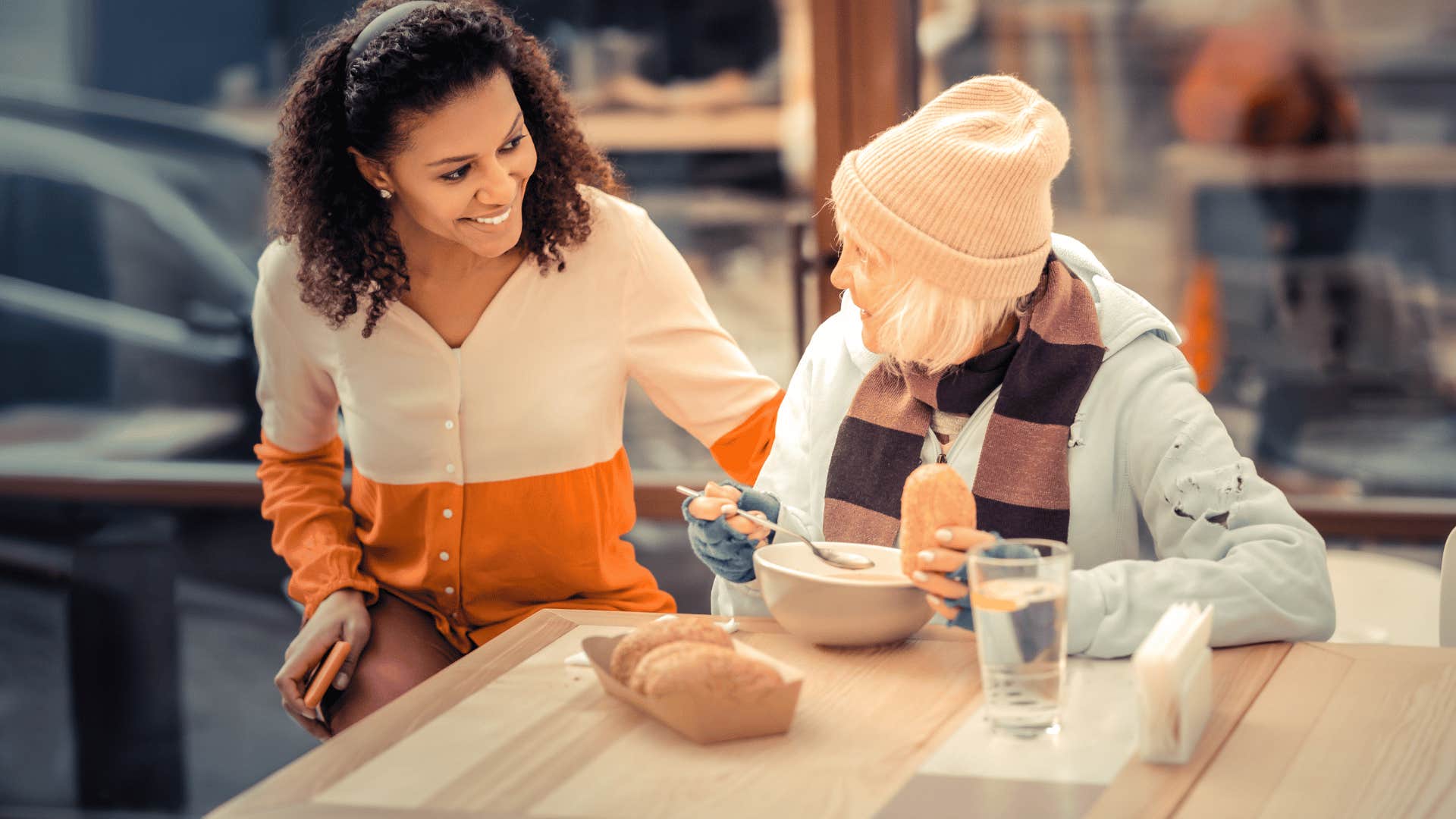 woman helping elderly woman 