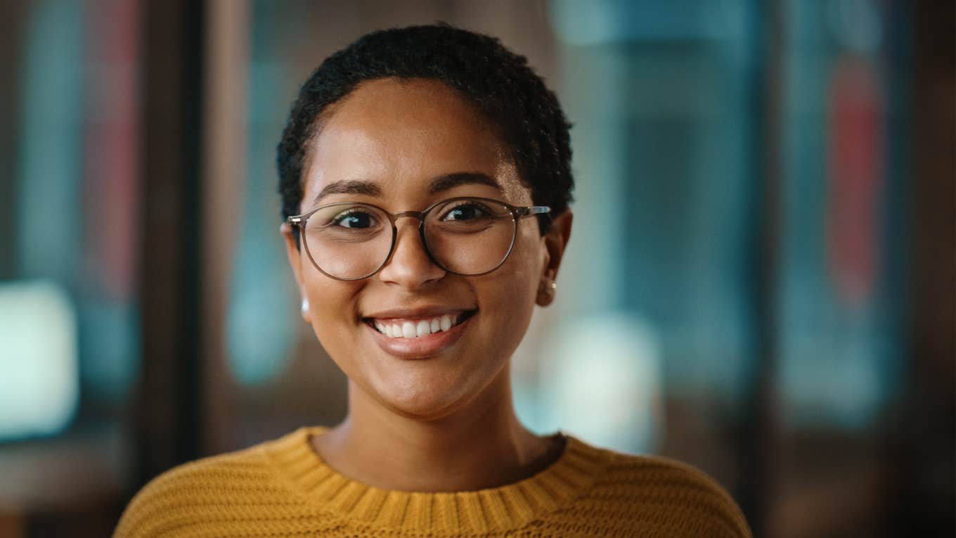 sophisticated young woman with glasses smiling