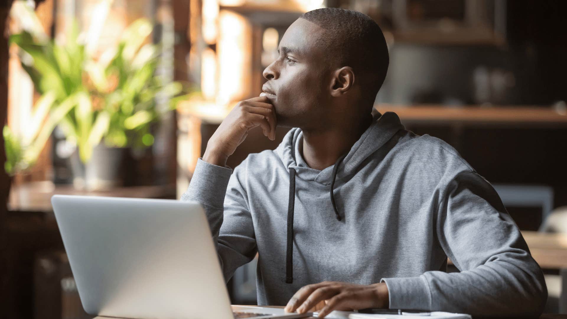 man staring off into space while thinking 