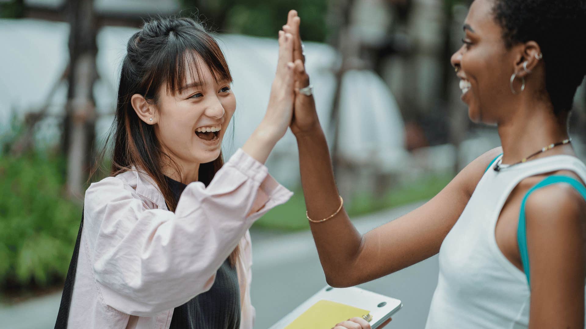 two women high fiving each other