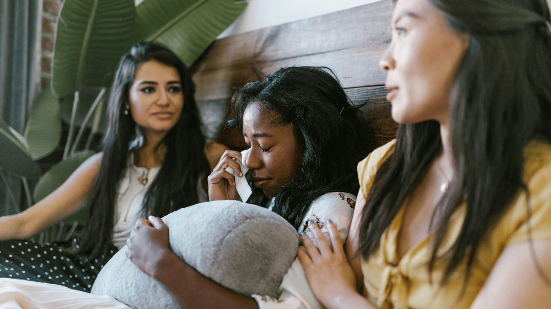 two women comforting crying friend