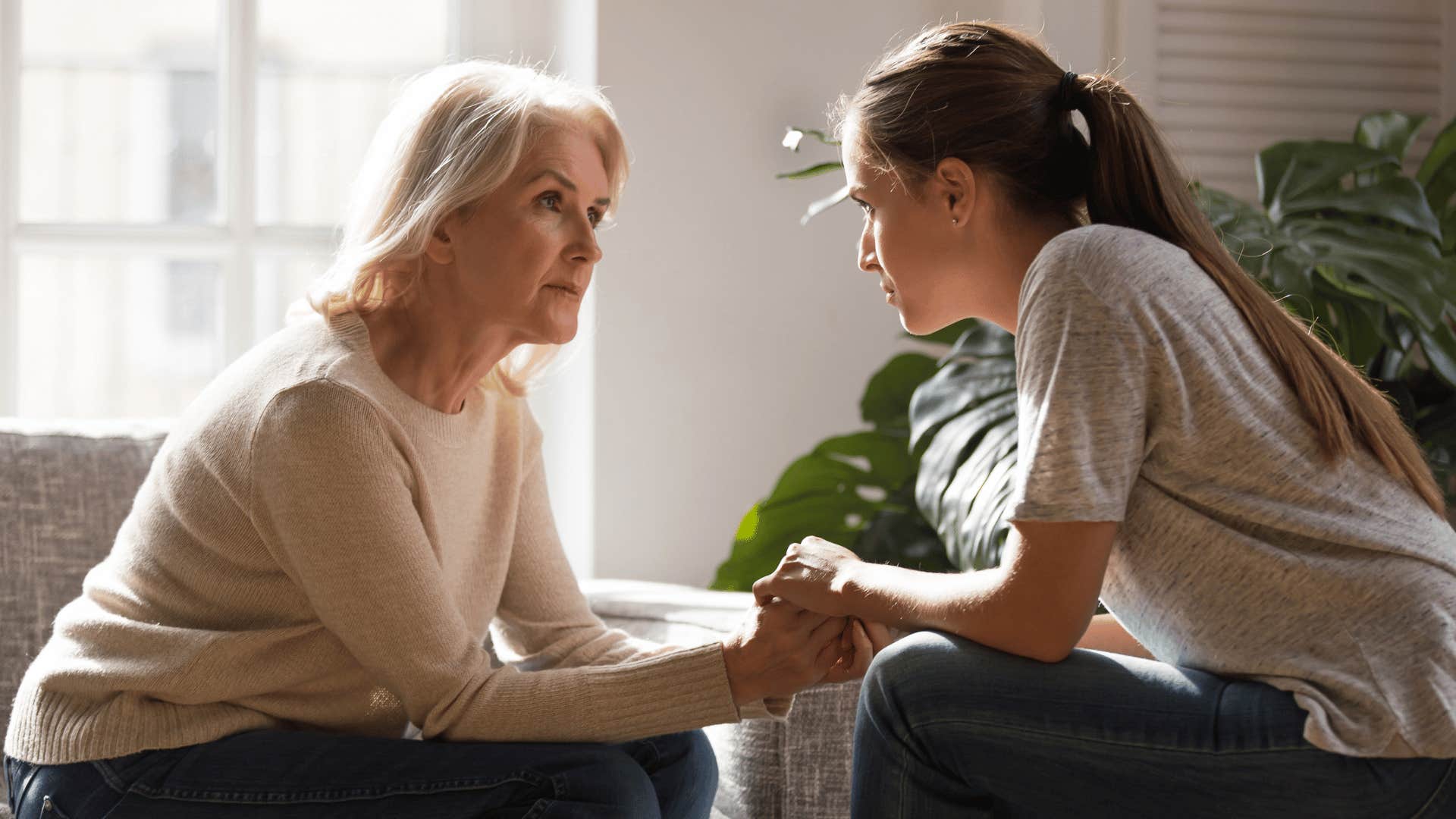 two women facing each other and holding hands 