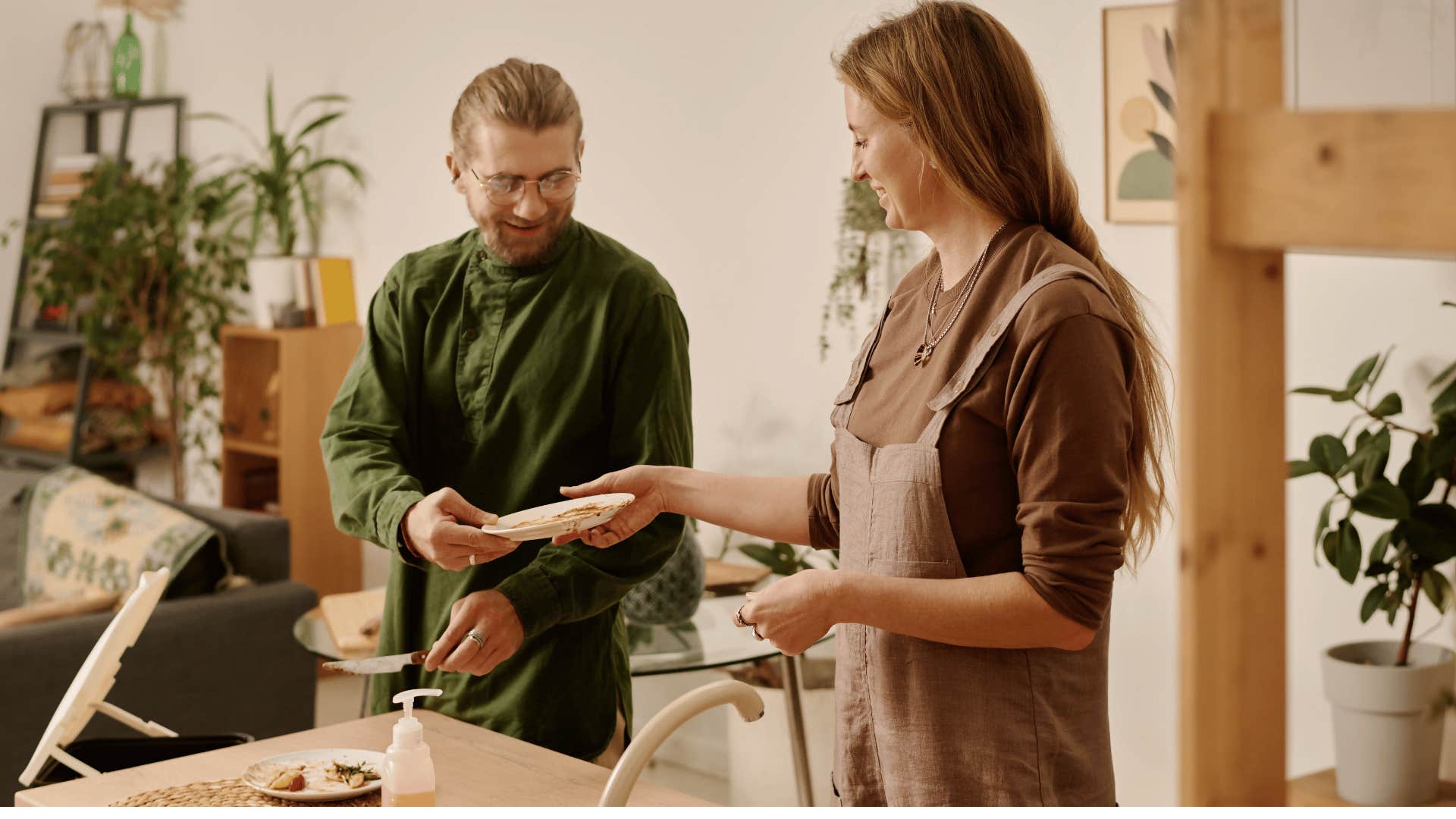 man and woman washing dishes together