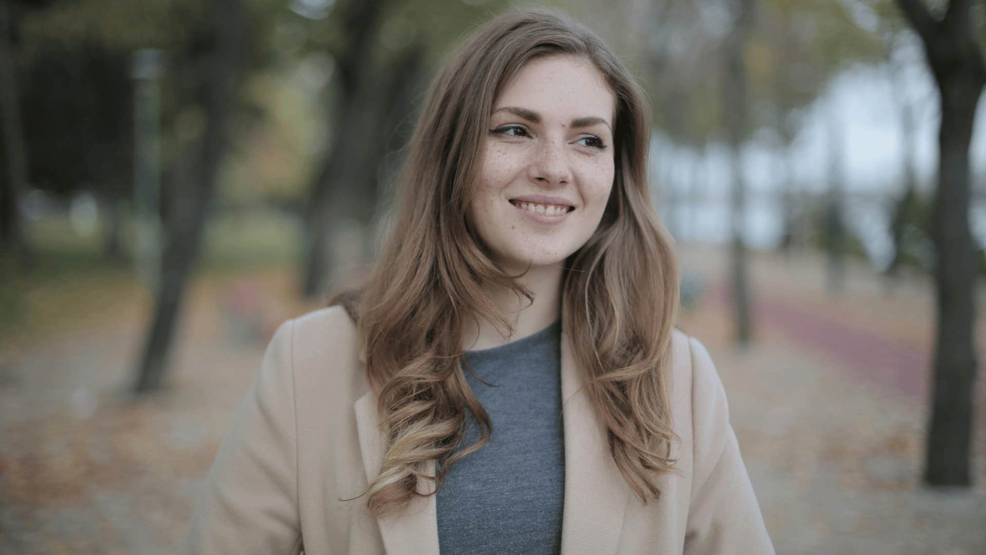 woman walking and smiling slightly 