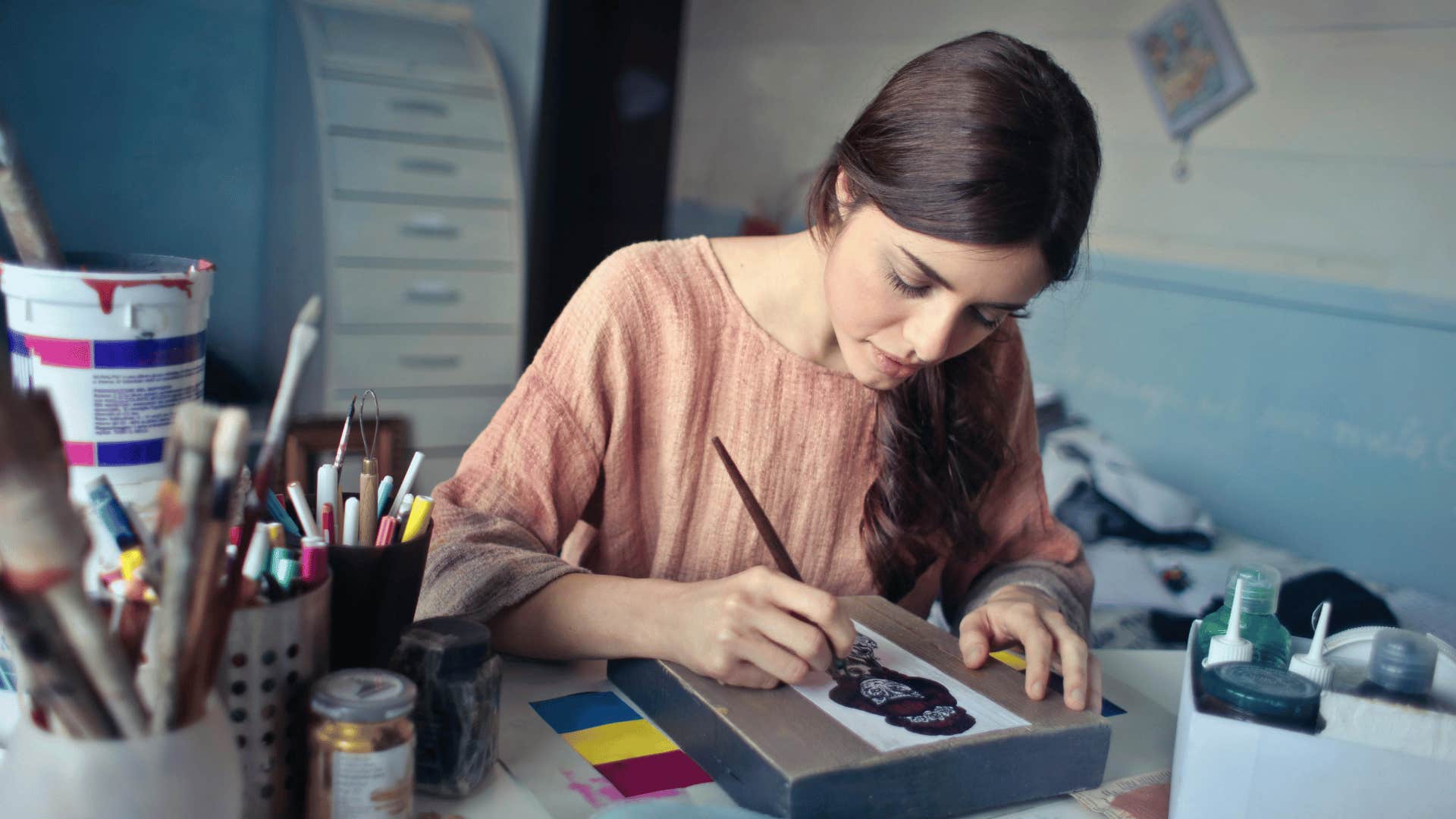 woman painting on desk 