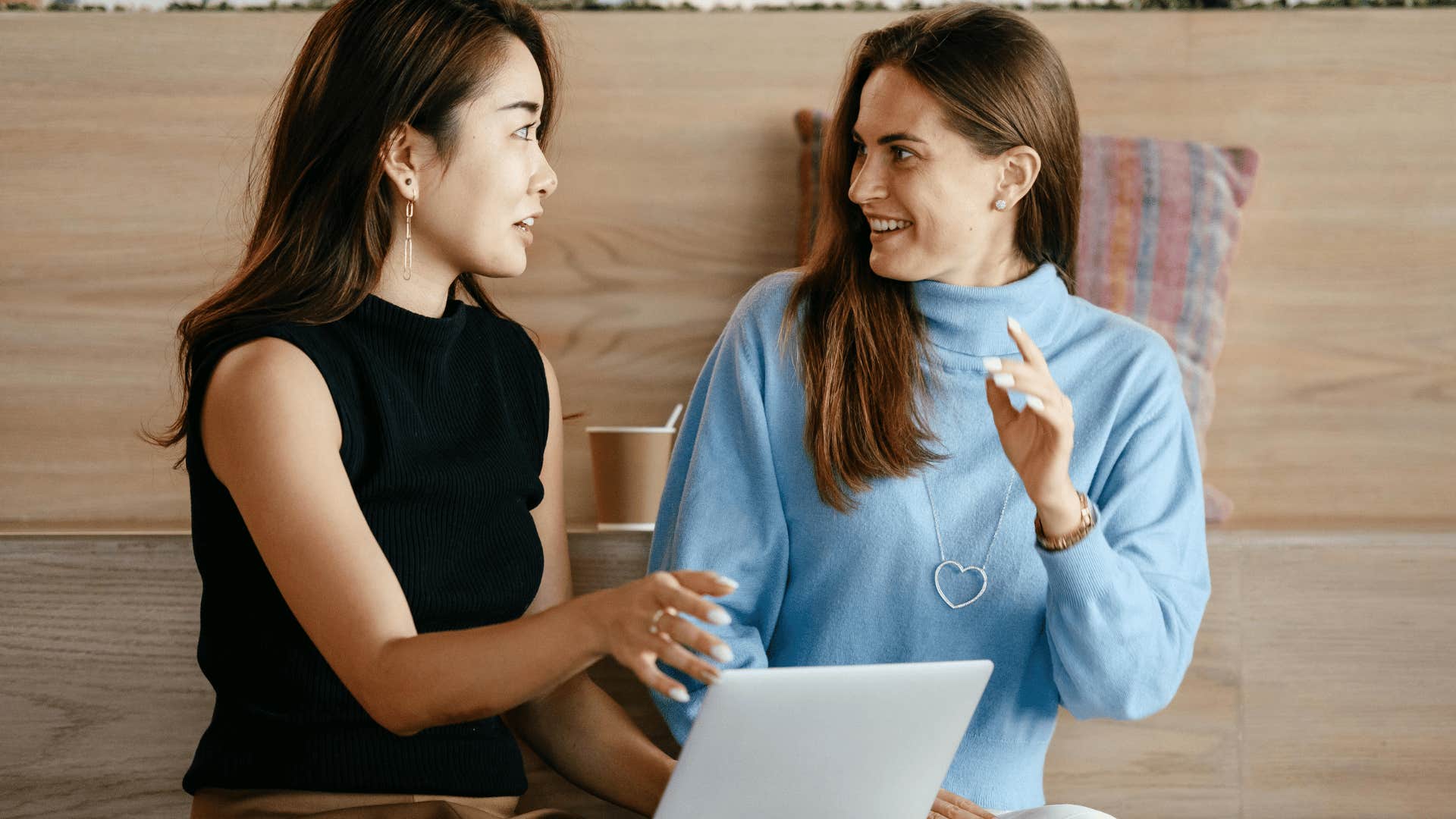 women talking and asking questions