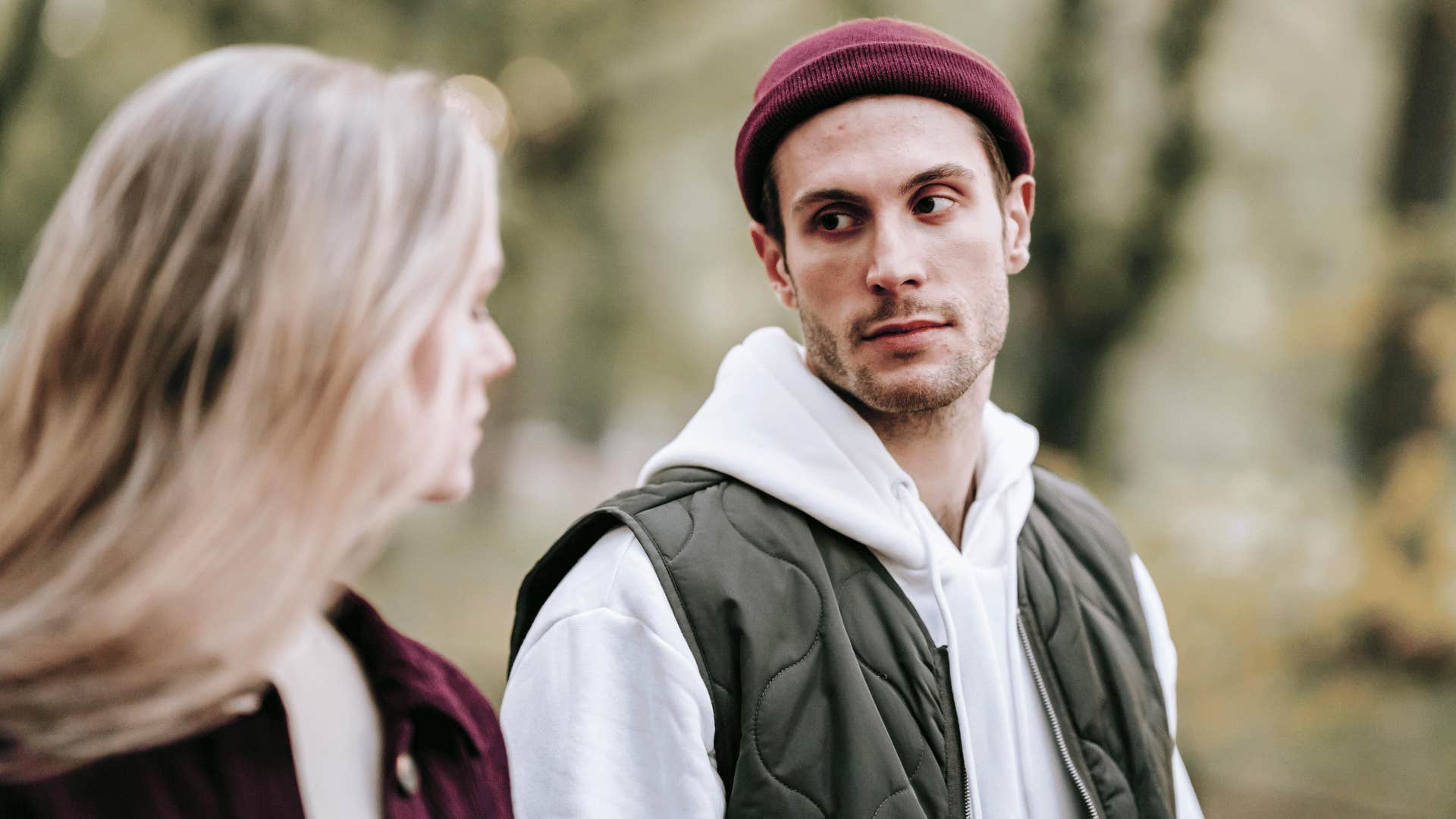 man listening to woman talk