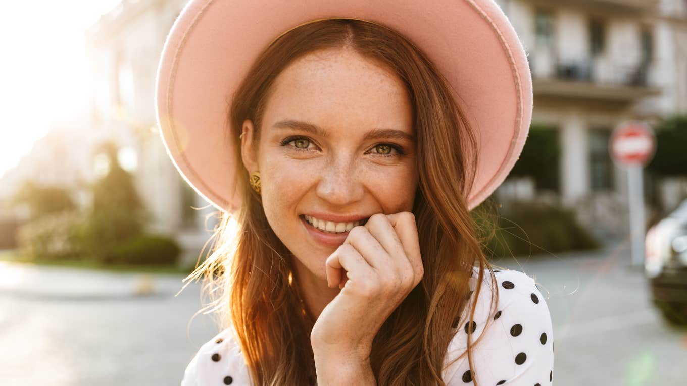 cheery woman in a pink hat