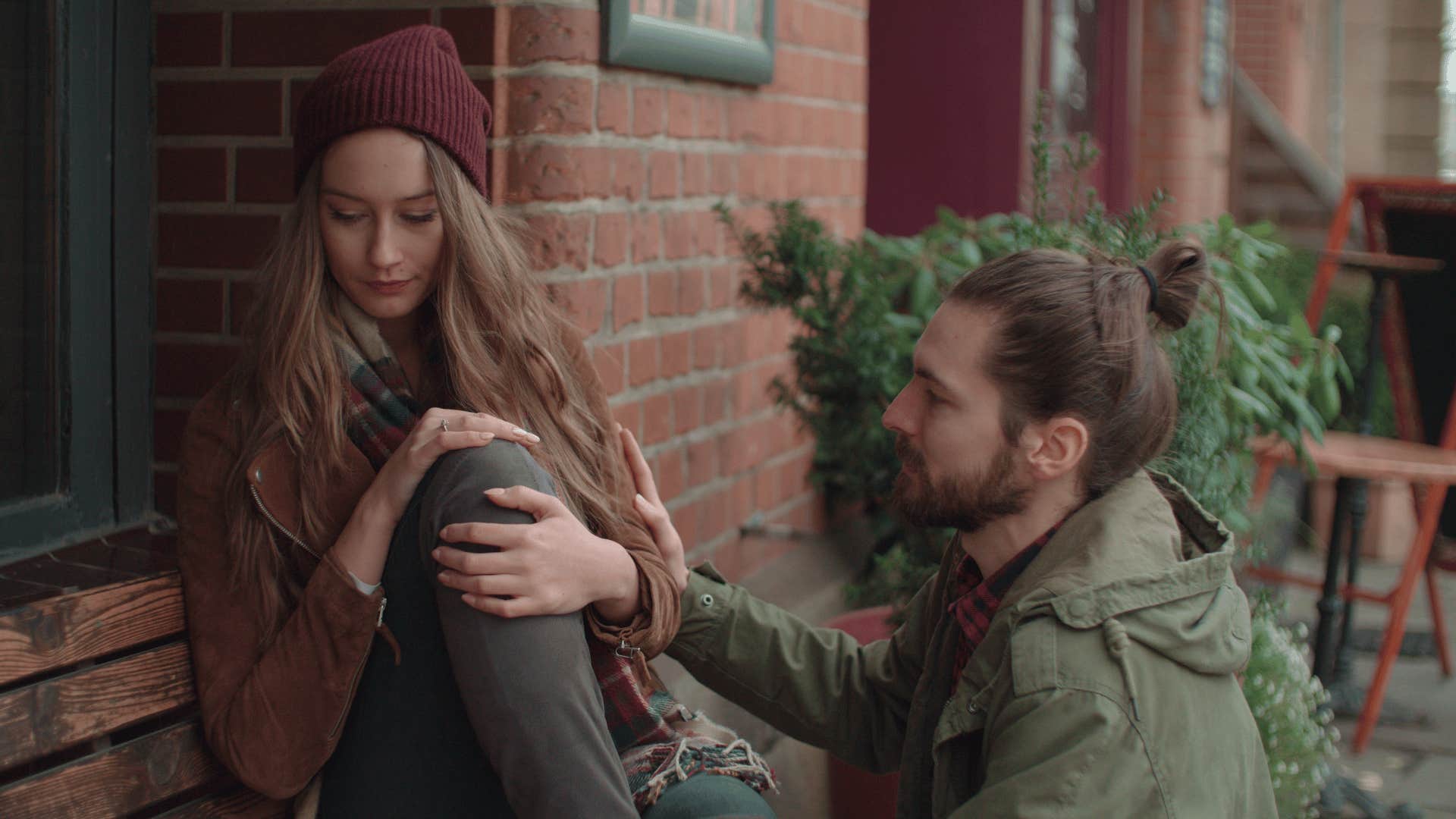 man comforting a woman