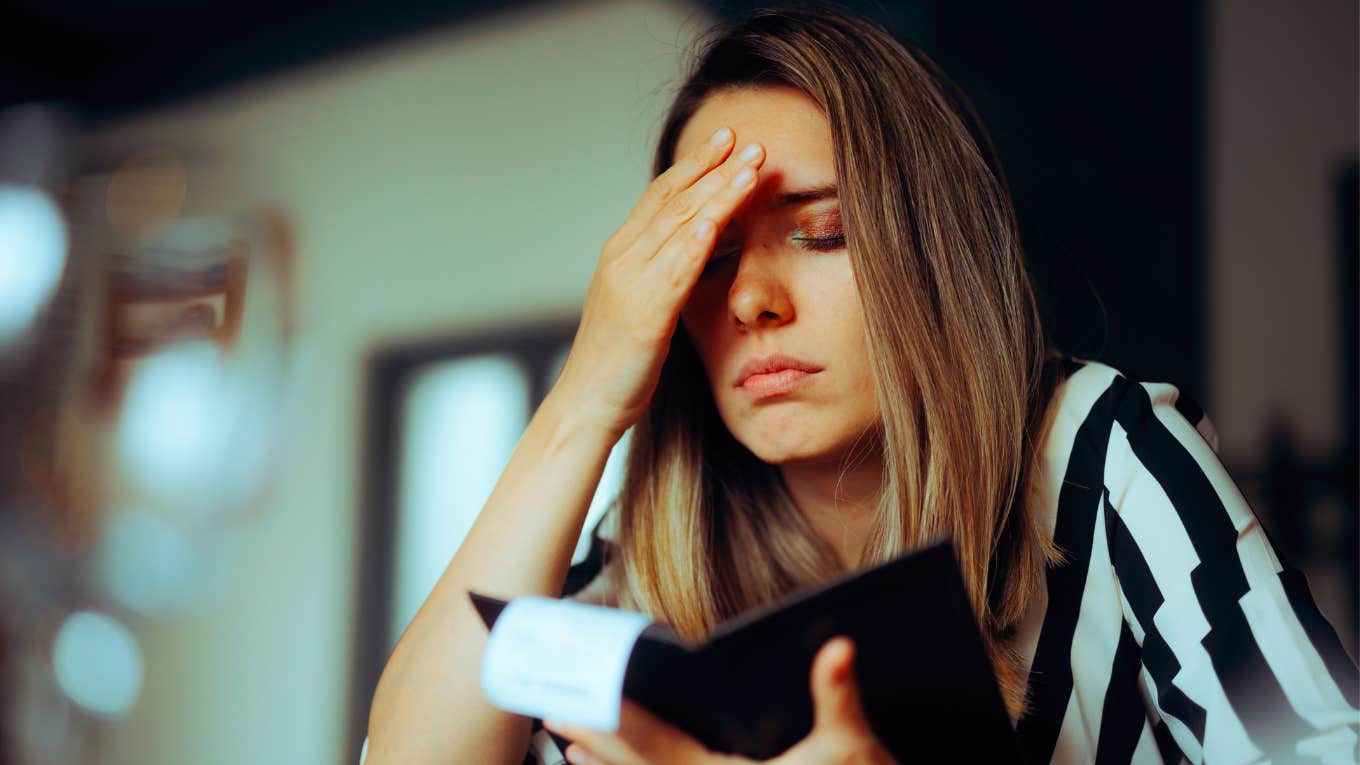 woman stressed after receiving restaurant tab