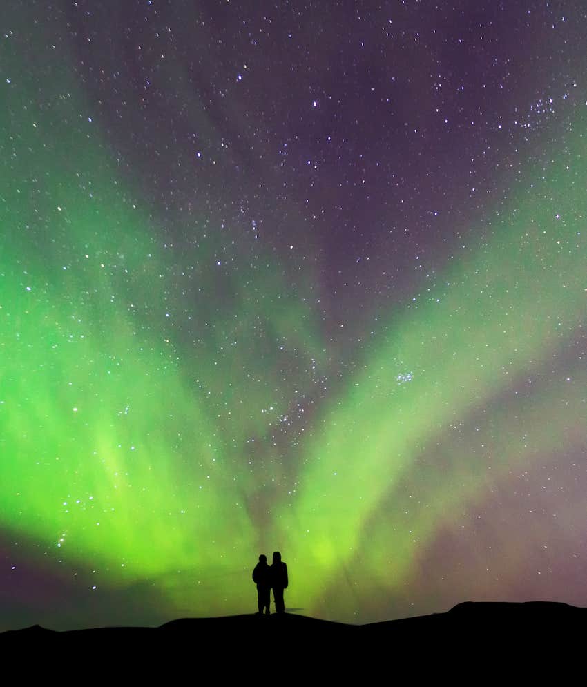 Magnetically charged green aurora with couple