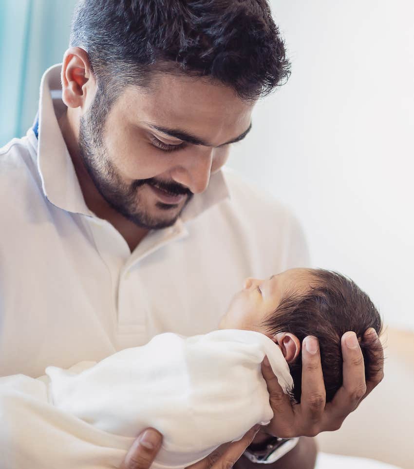 Father holds infant and hopes to not have a difficult mariage