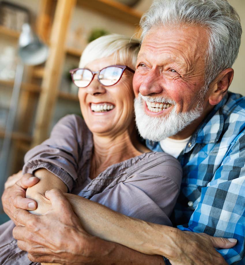 Older hugging couple in love have kept old-fashioned habits