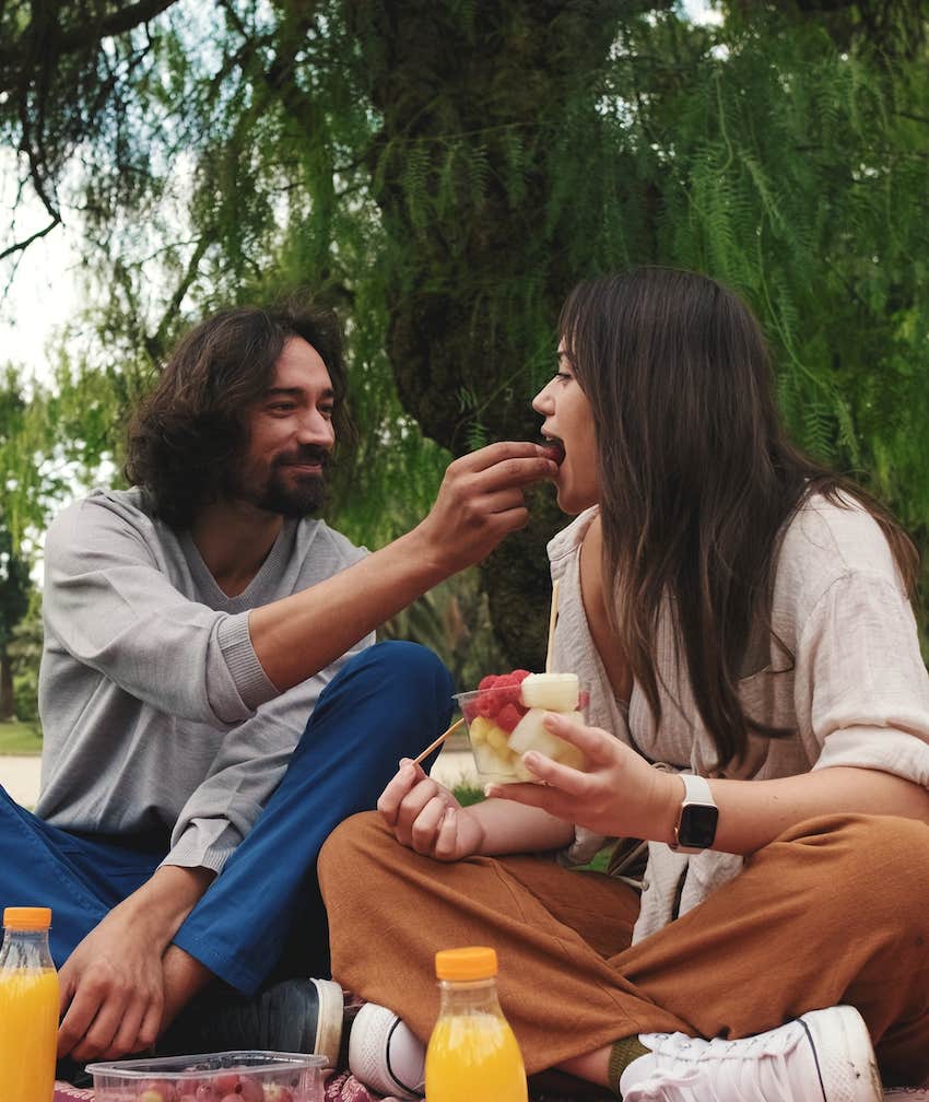 Couple on an old-fashioned picnic bring back love as he feeds her