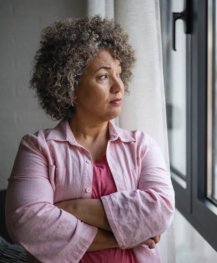 Woman stares out window fantasizing about finding The One