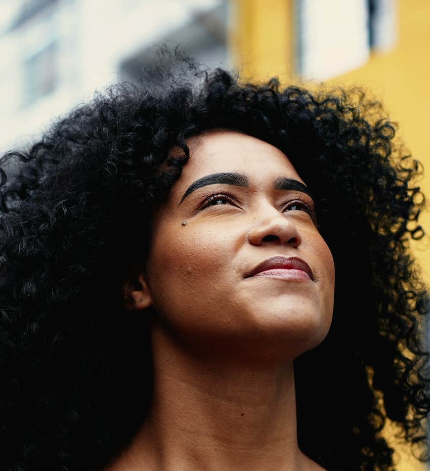 Confident women looks up and thinks of overcoming her biggest hurdle