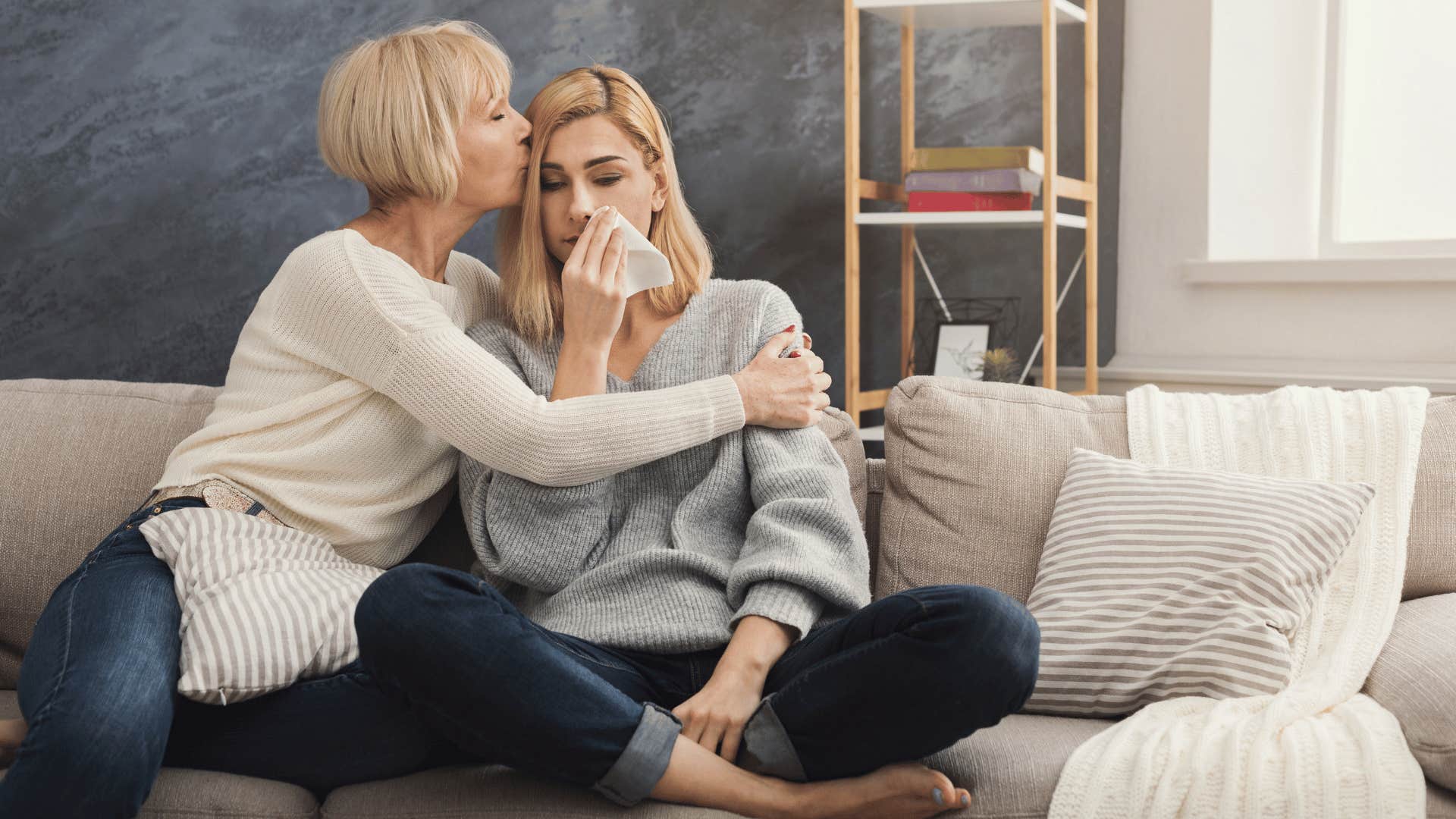 mom comforting adult daughter