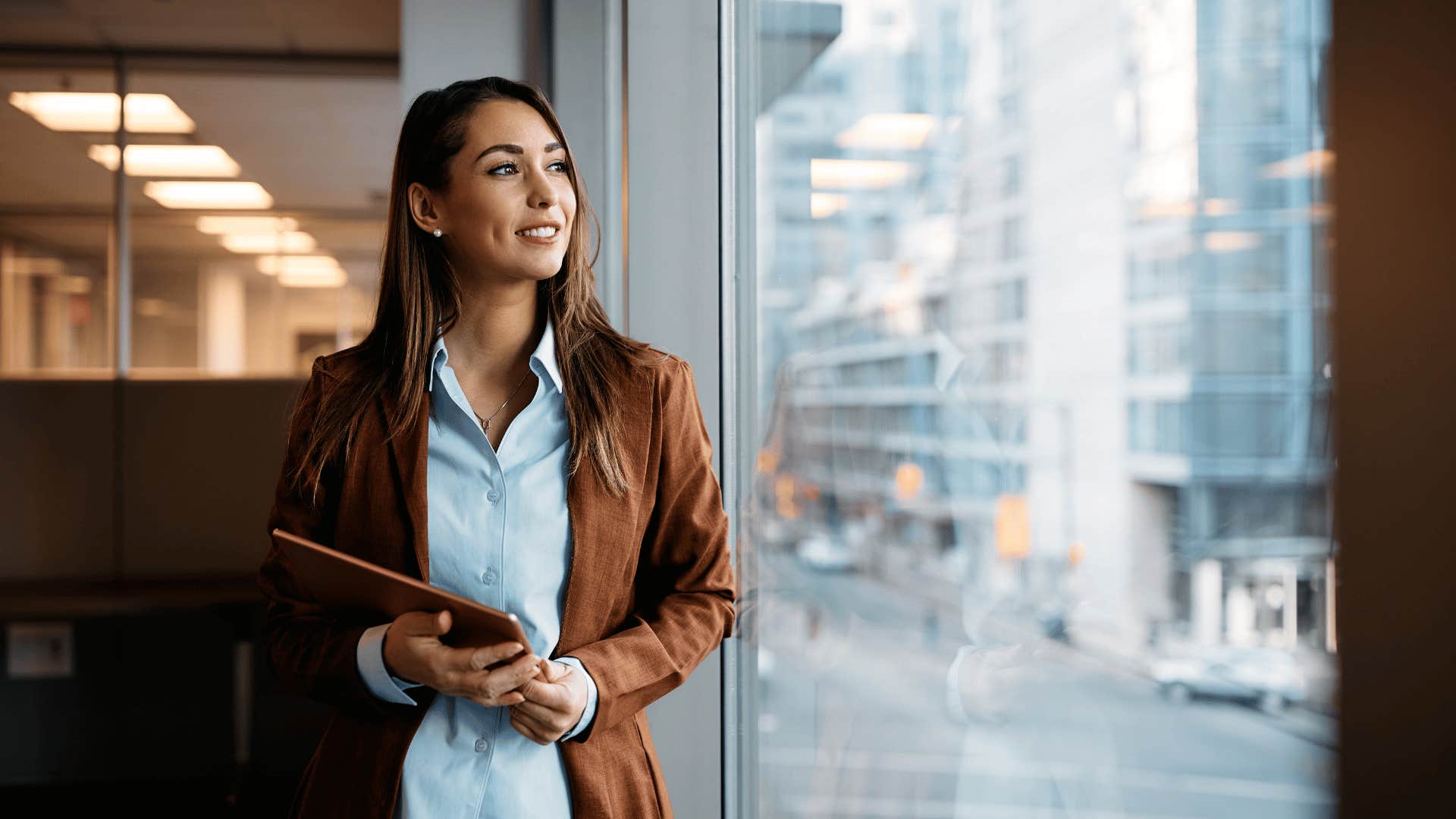 woman thinking deeply and looking out window 