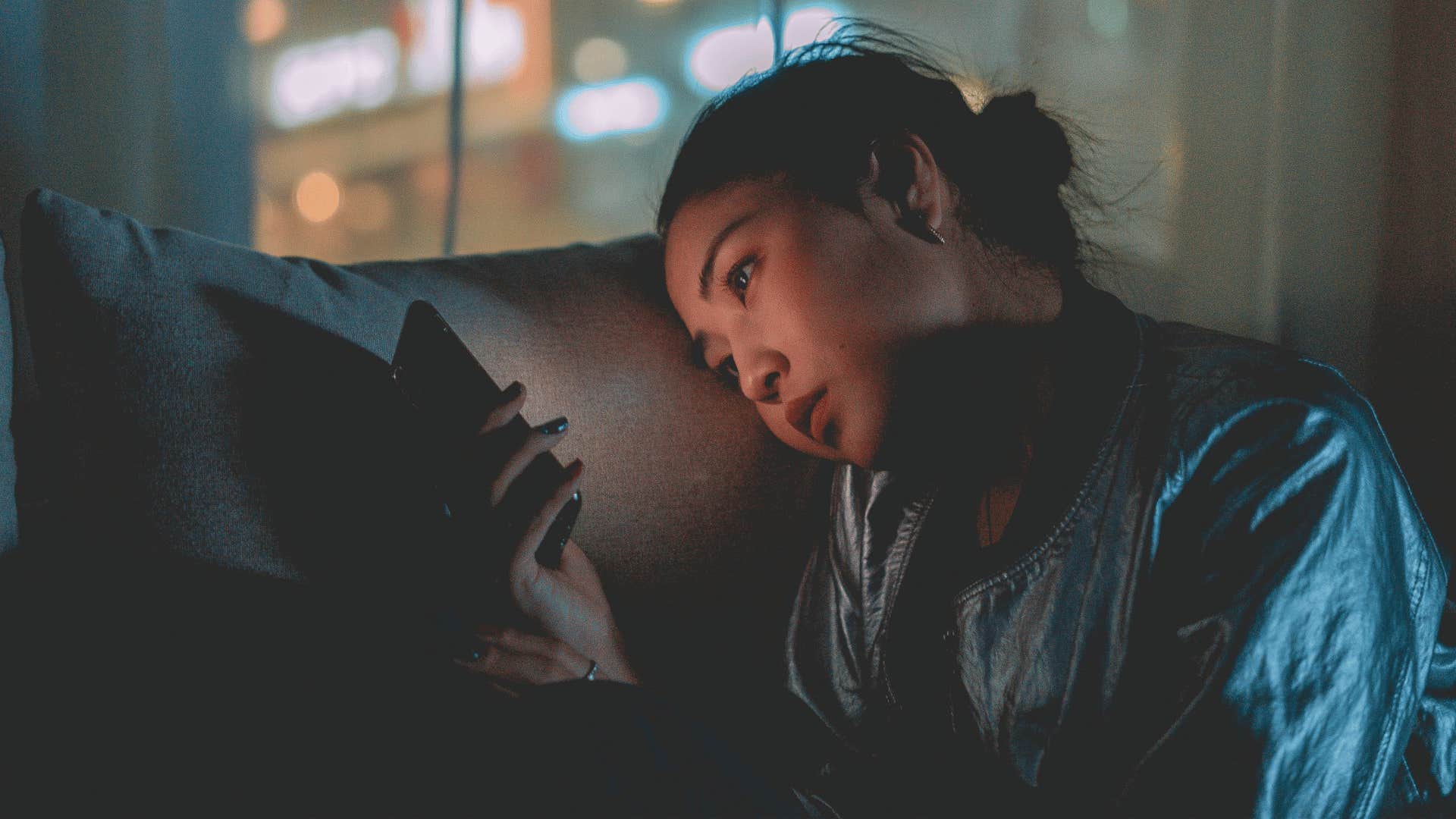 woman staring at phone looking done