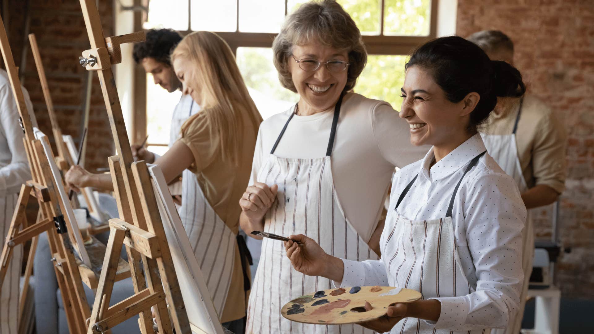 genius woman painting and talking to teacher