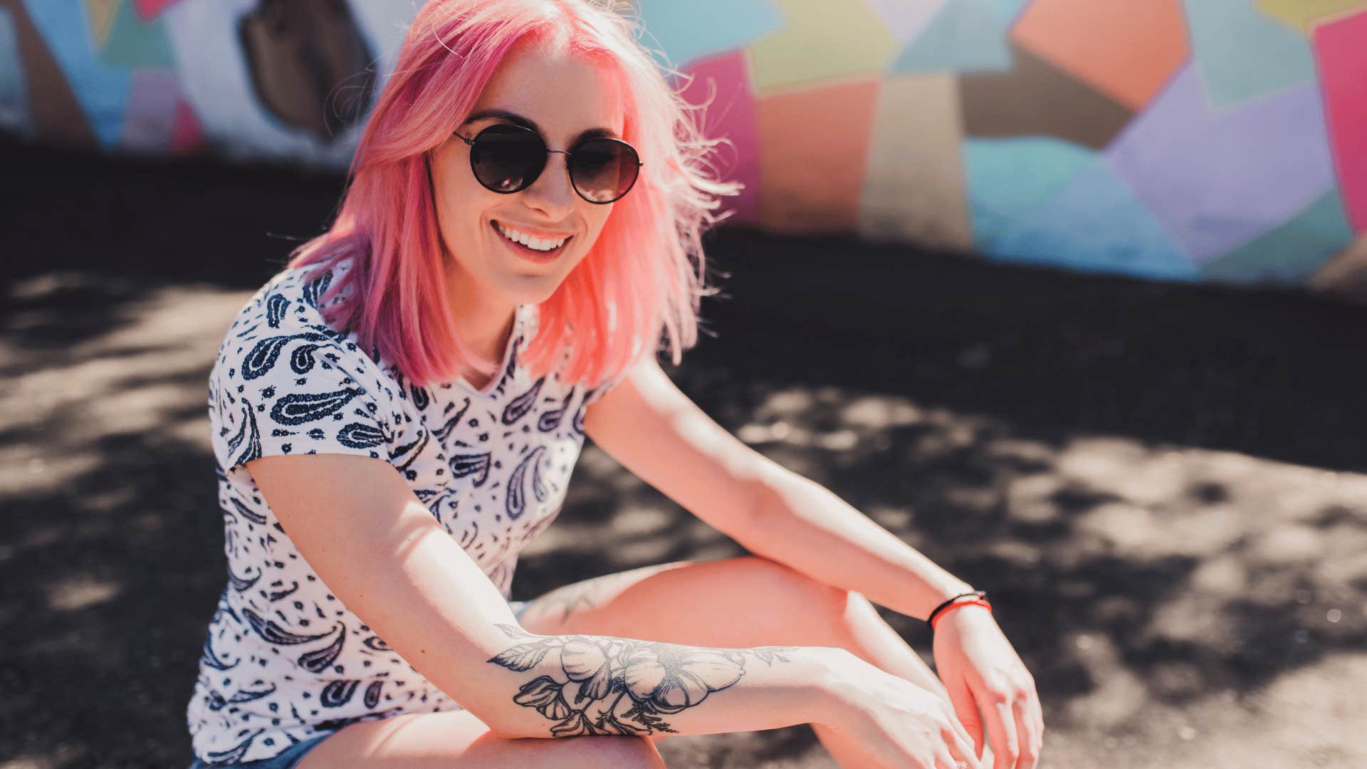 woman with pink hair smiling 