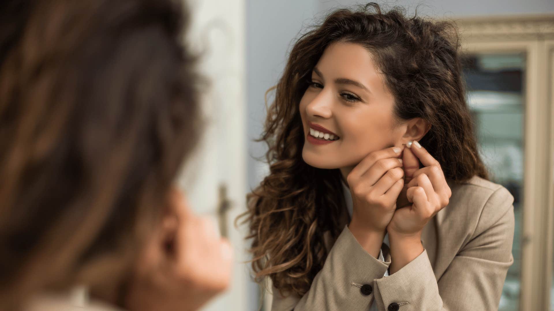 woman looking at herself in mirror