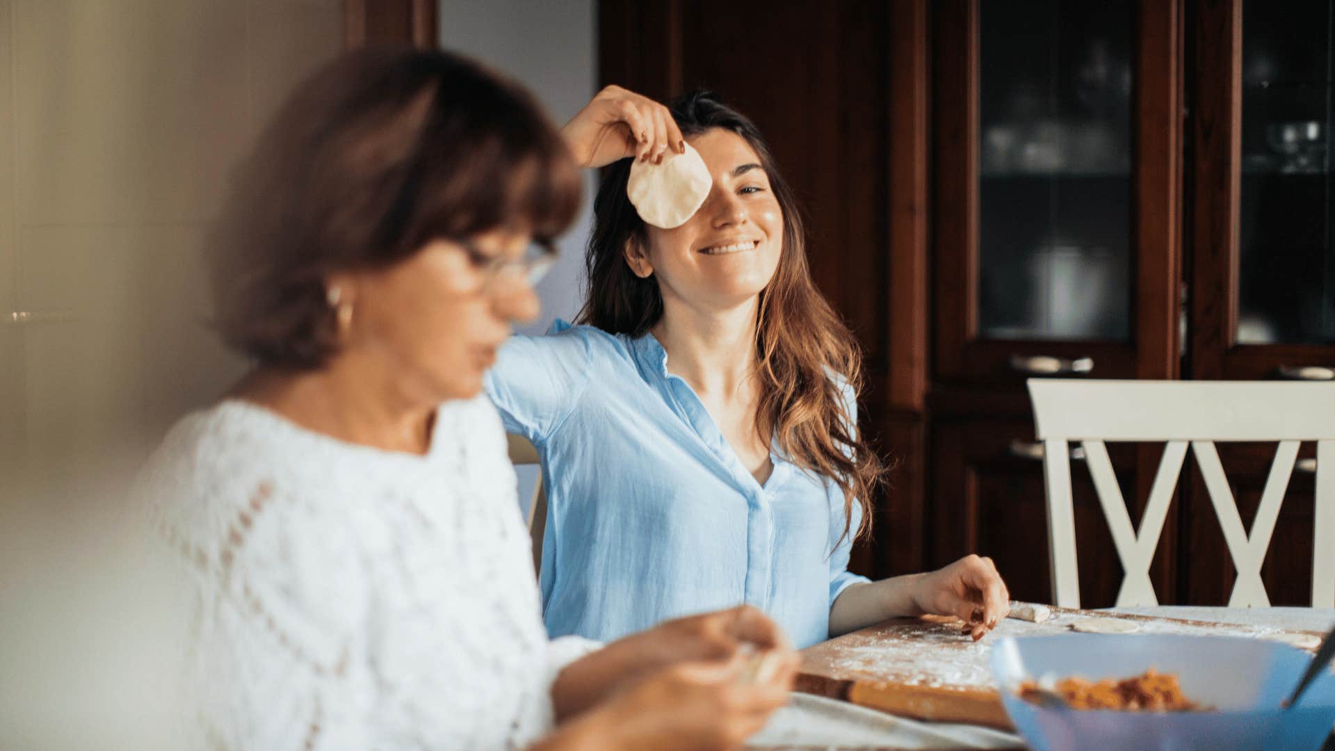 woman being silly and holding up food to eye