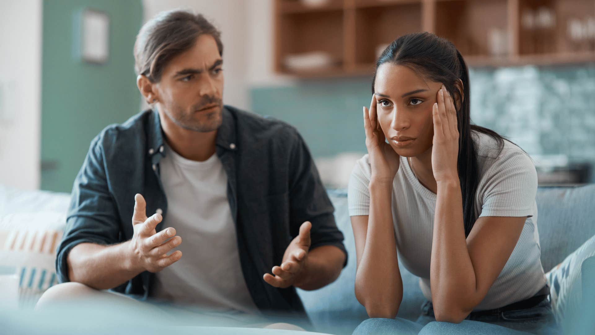 woman looking fed up while man talks 