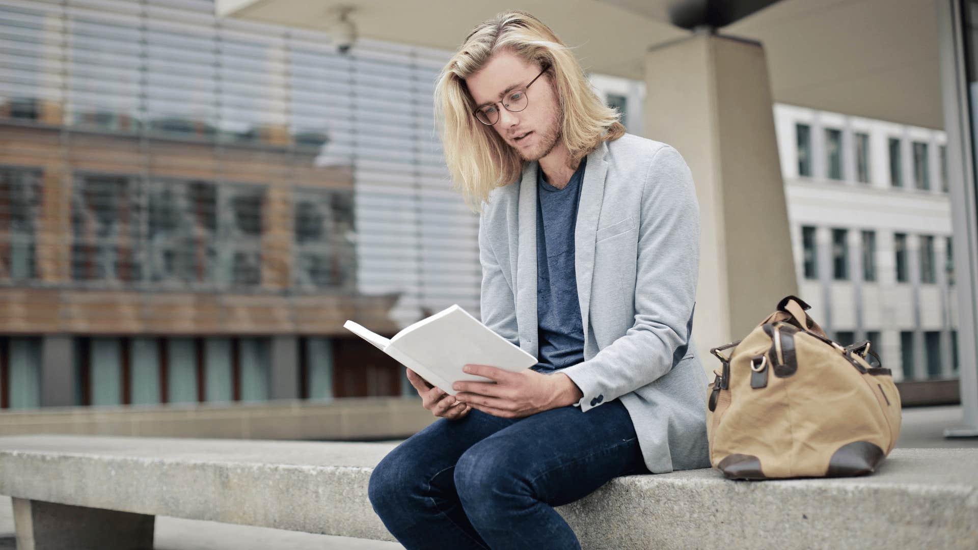 man reading book alone