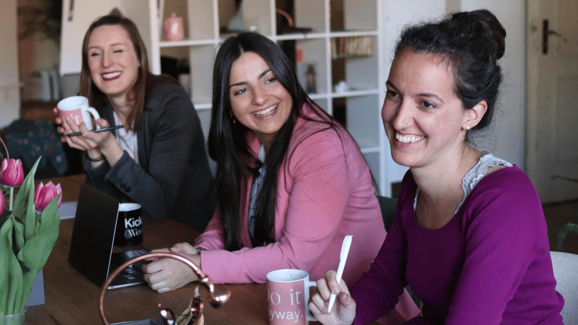 three woman laughing together 