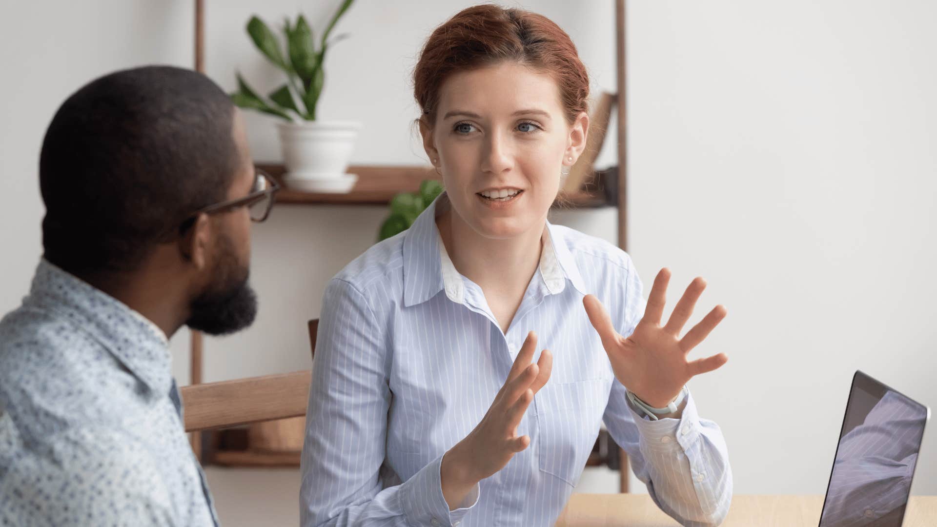 woman explaining something to man 