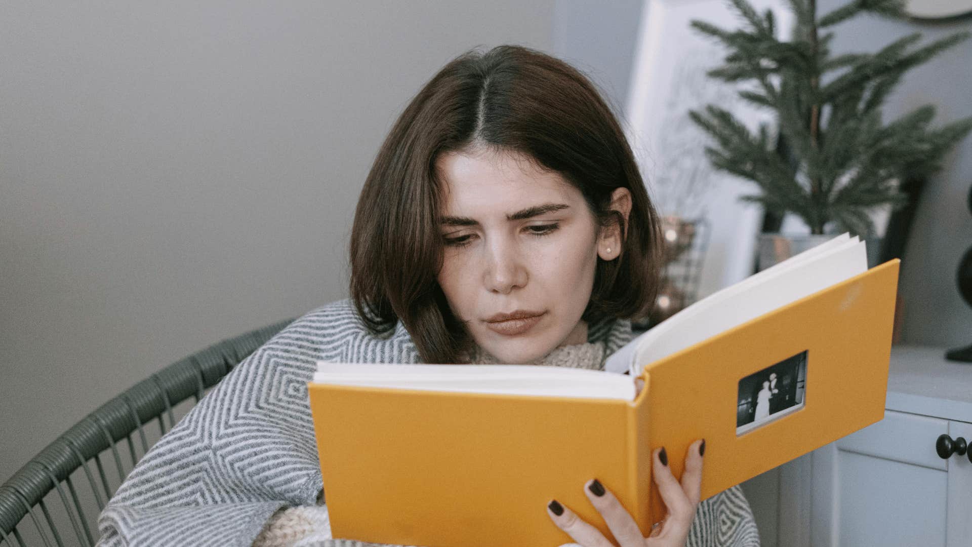 woman looking at a photo album