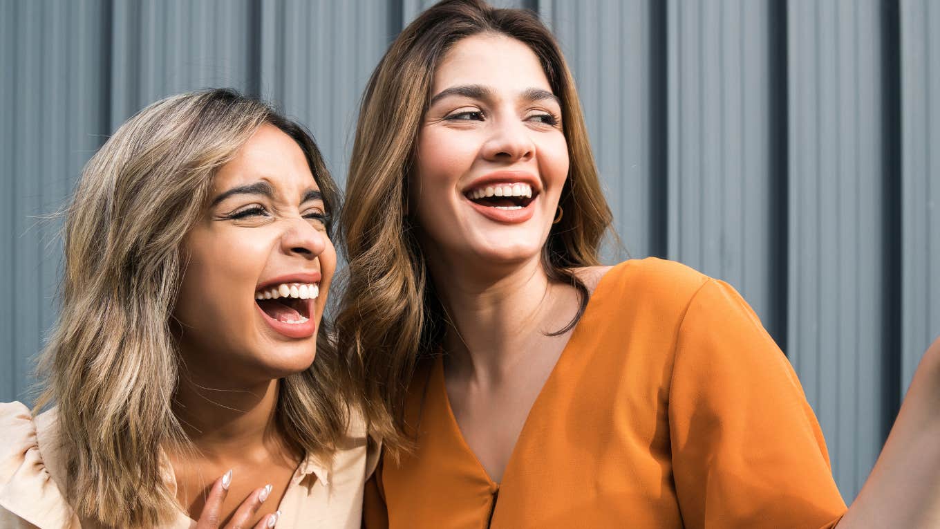 Two women with fake smiles together