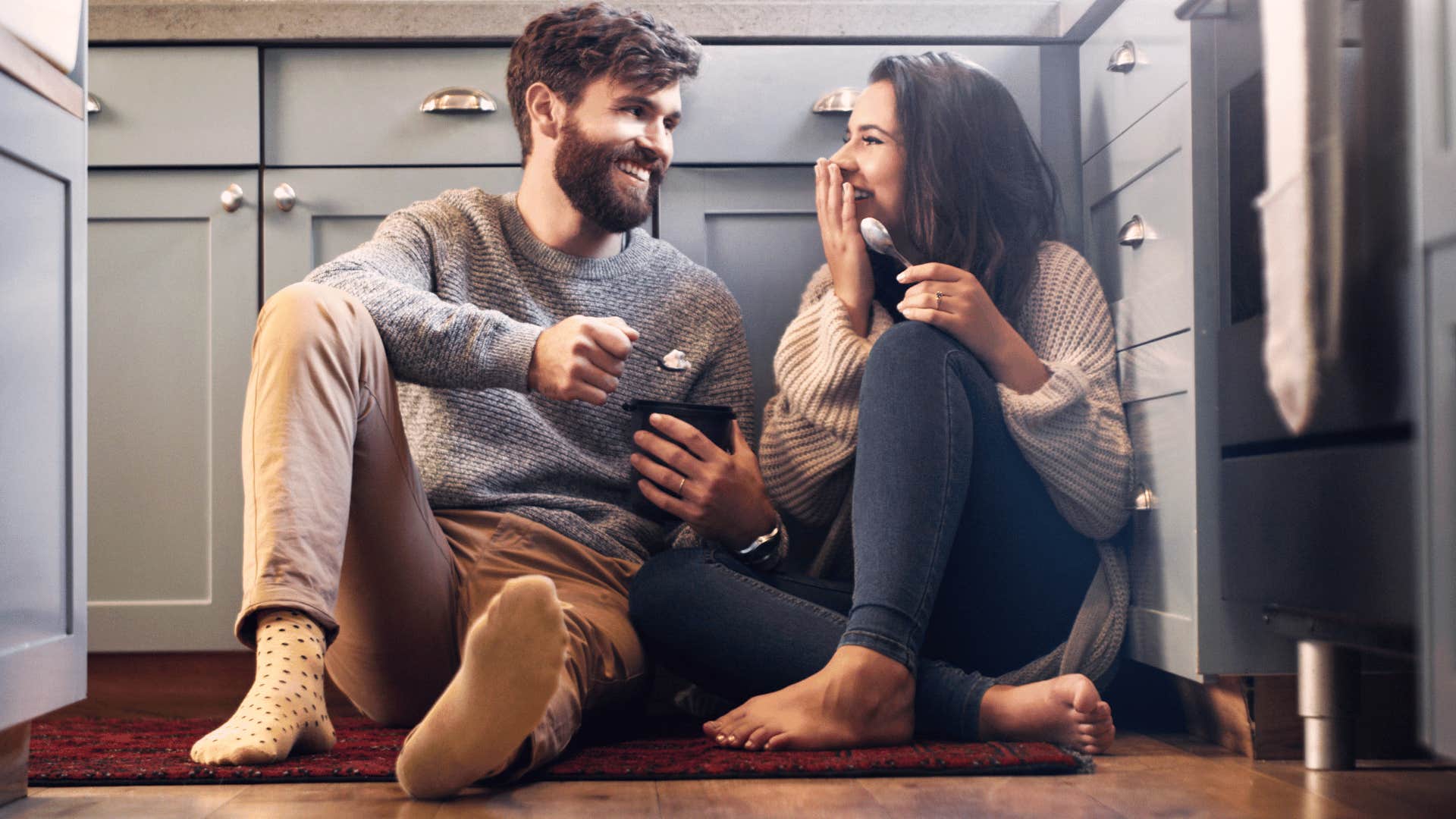 couple eating ice cream on kitchen floor