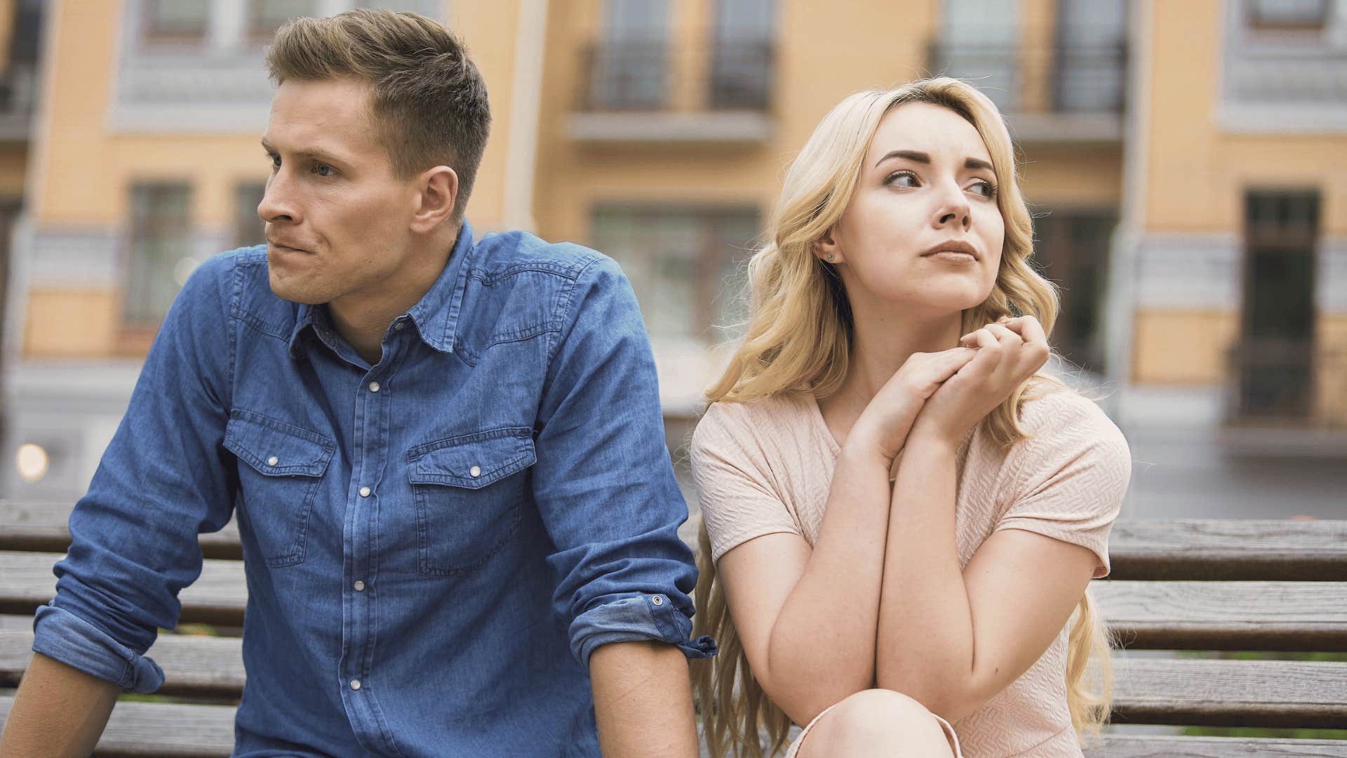 tense couple sitting on bench