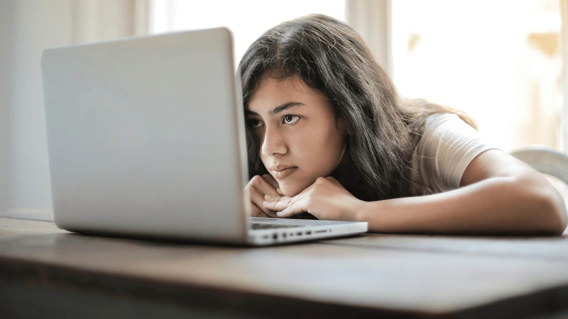 young woman looking at laptop screen 