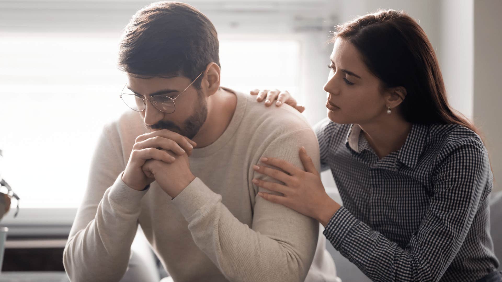 woman comforting upset man