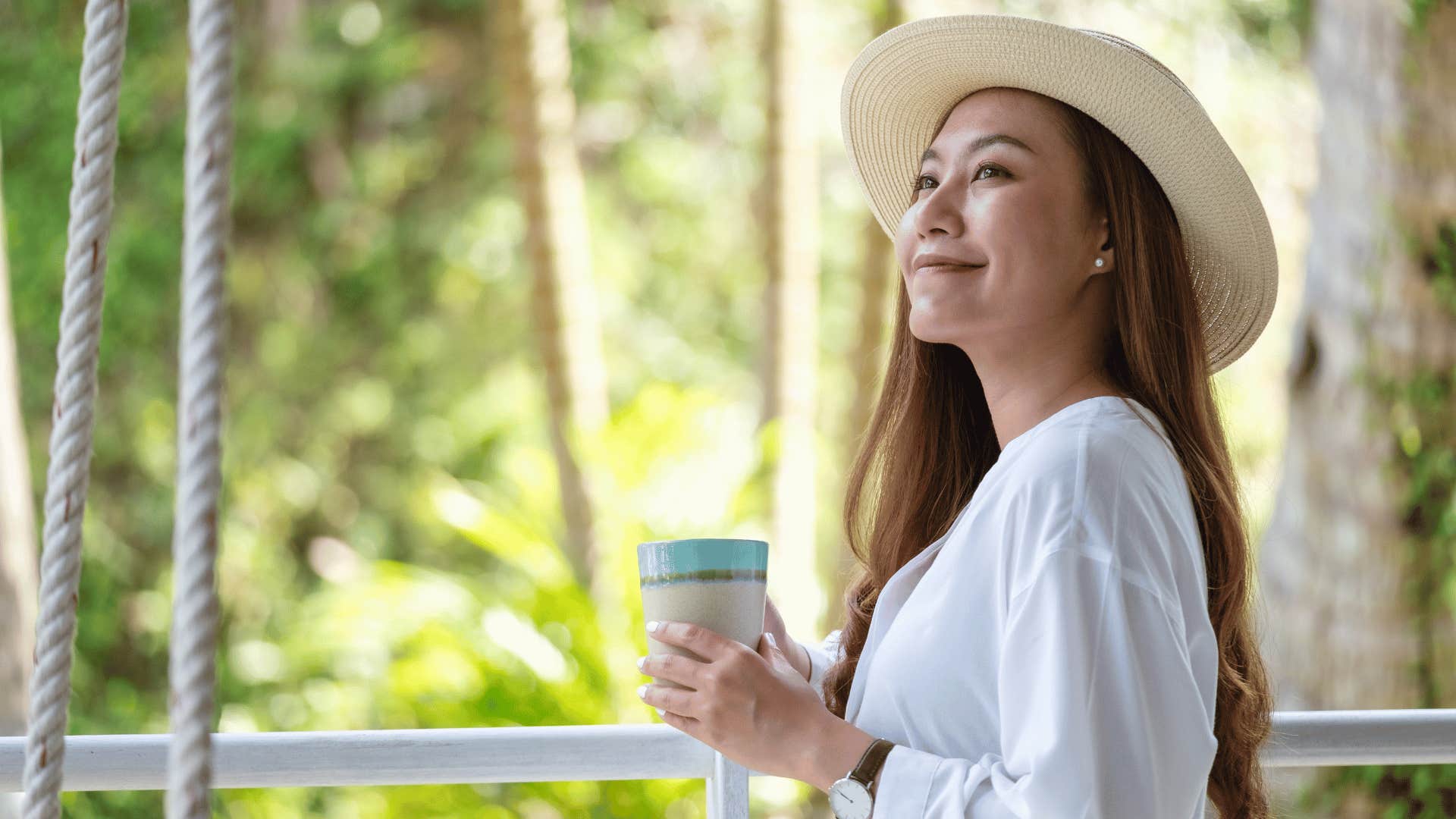 woman smiling with hot drink in hand 