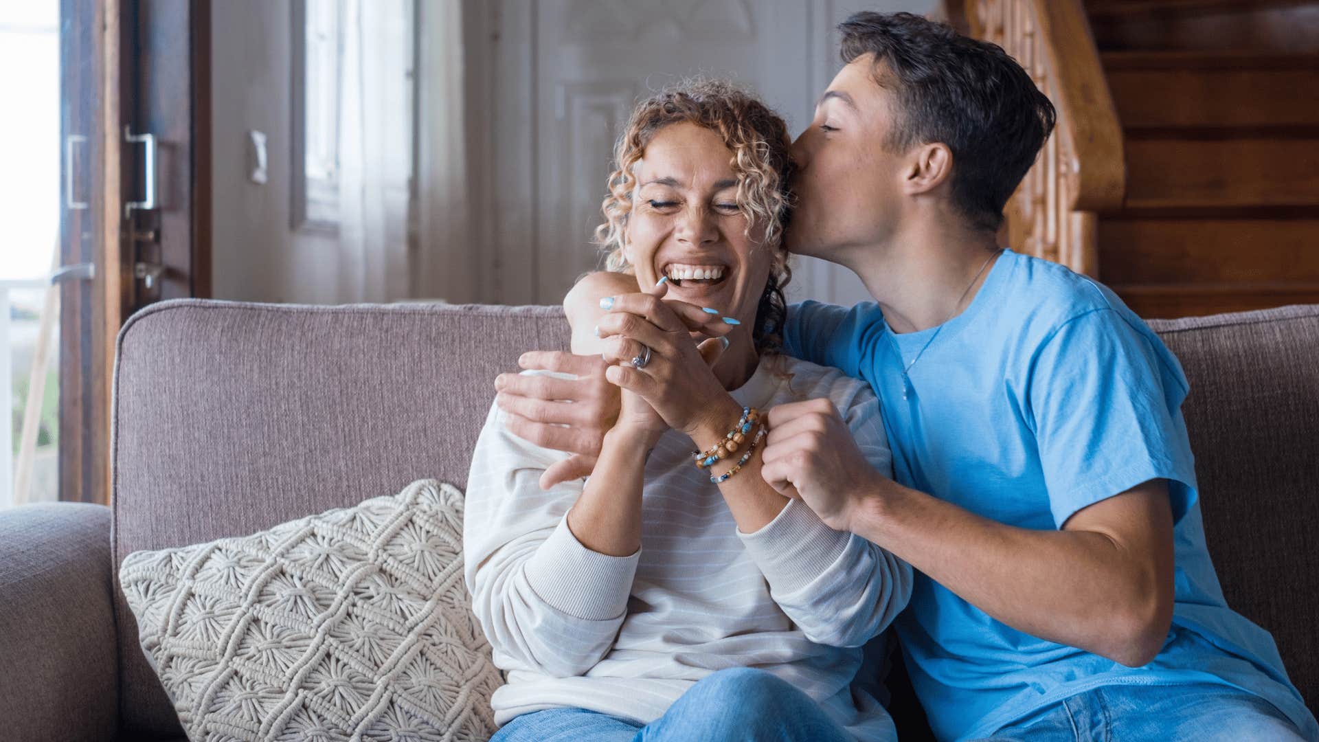 man being affectionate with woman and kissing head 