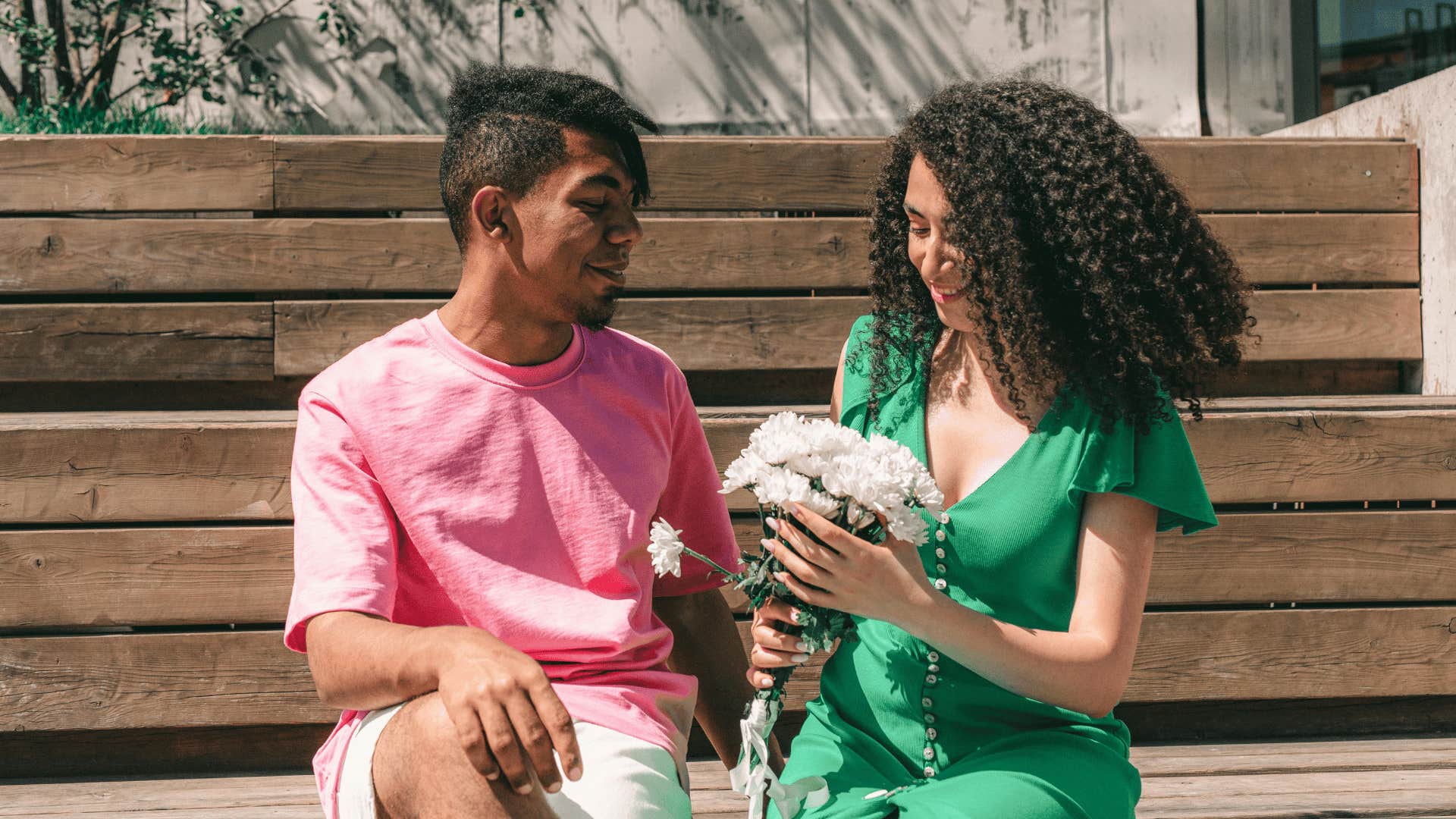 woman receiving flowers from man