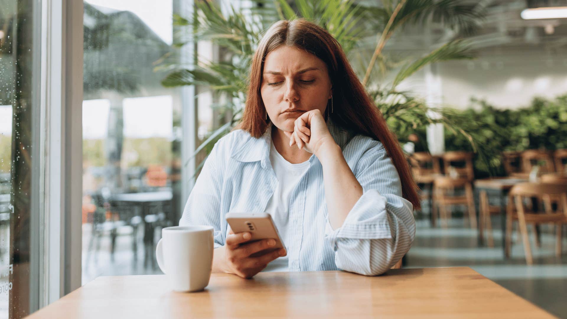 woman upset while looking at phone 