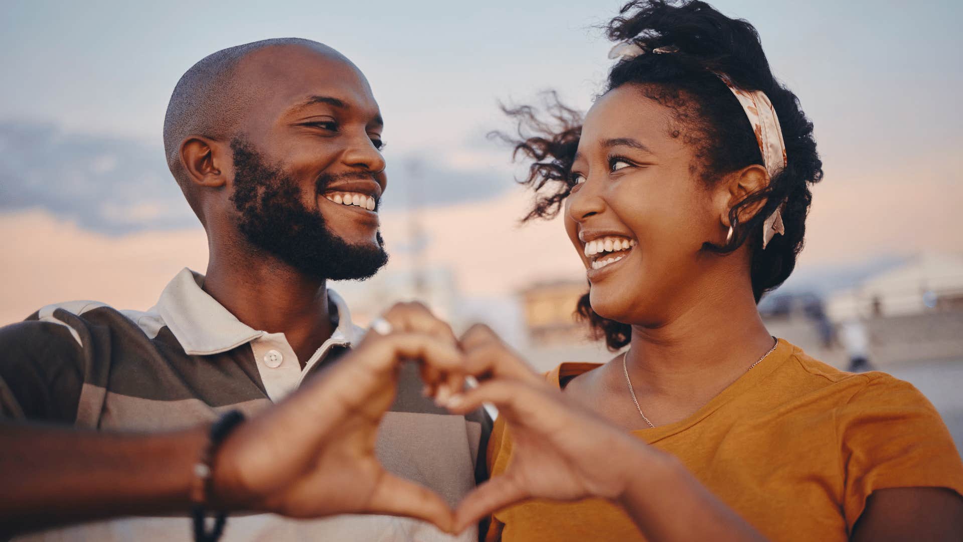 couple making a heart with their hands