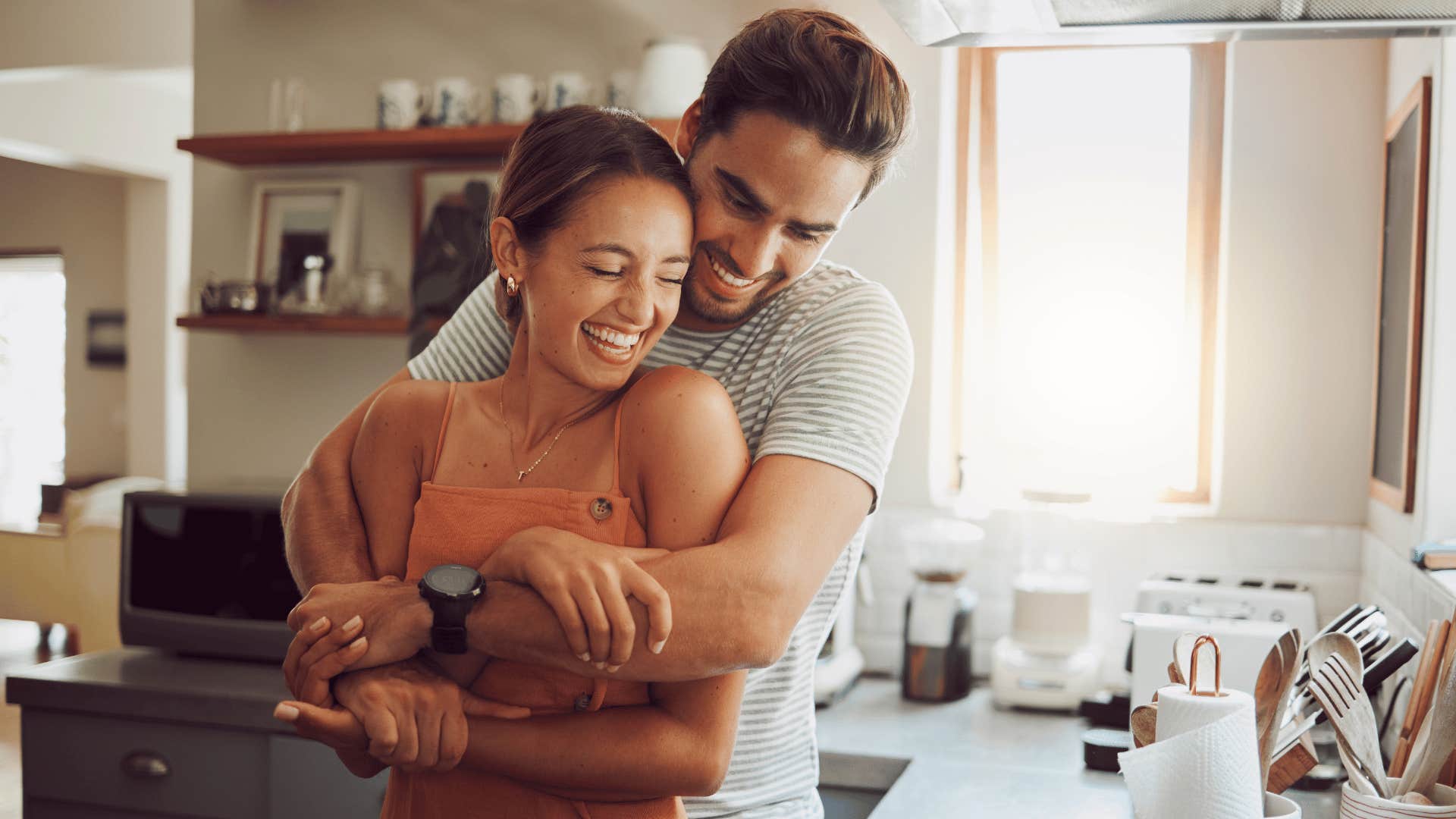 couple hugging in kitchen 