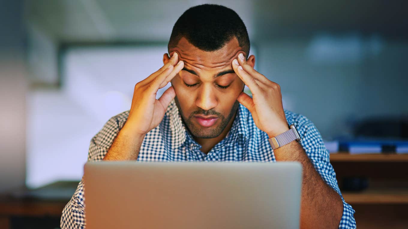 Man in front of computer is experiencing toxic stress.