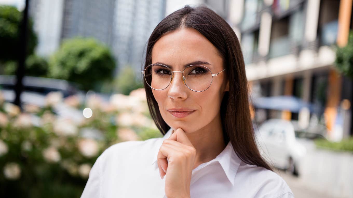 woman with glasses thinking deeply