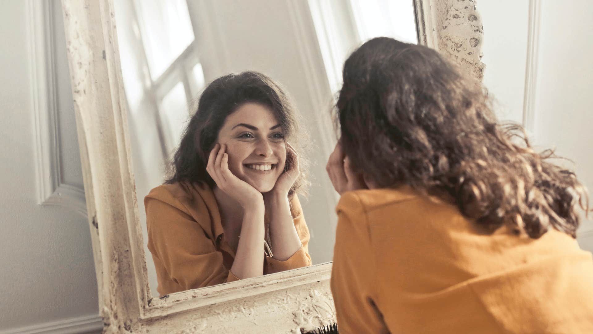 happy woman looking in mirror