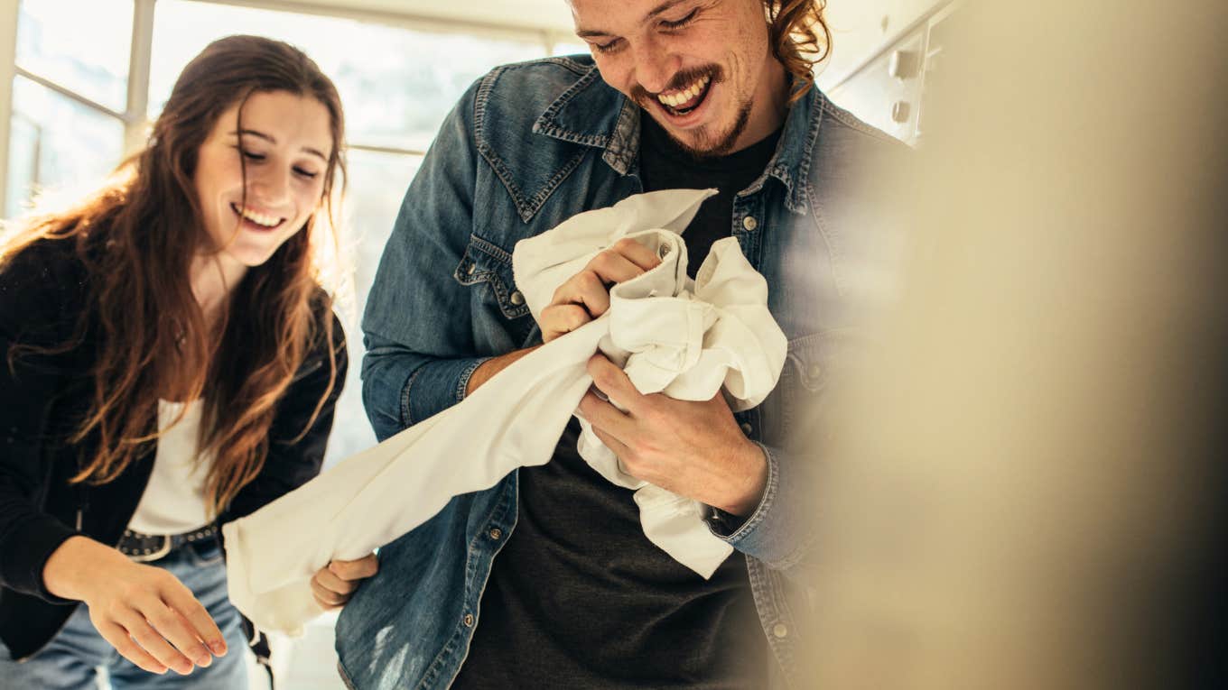 Husband helping wife with laundry 