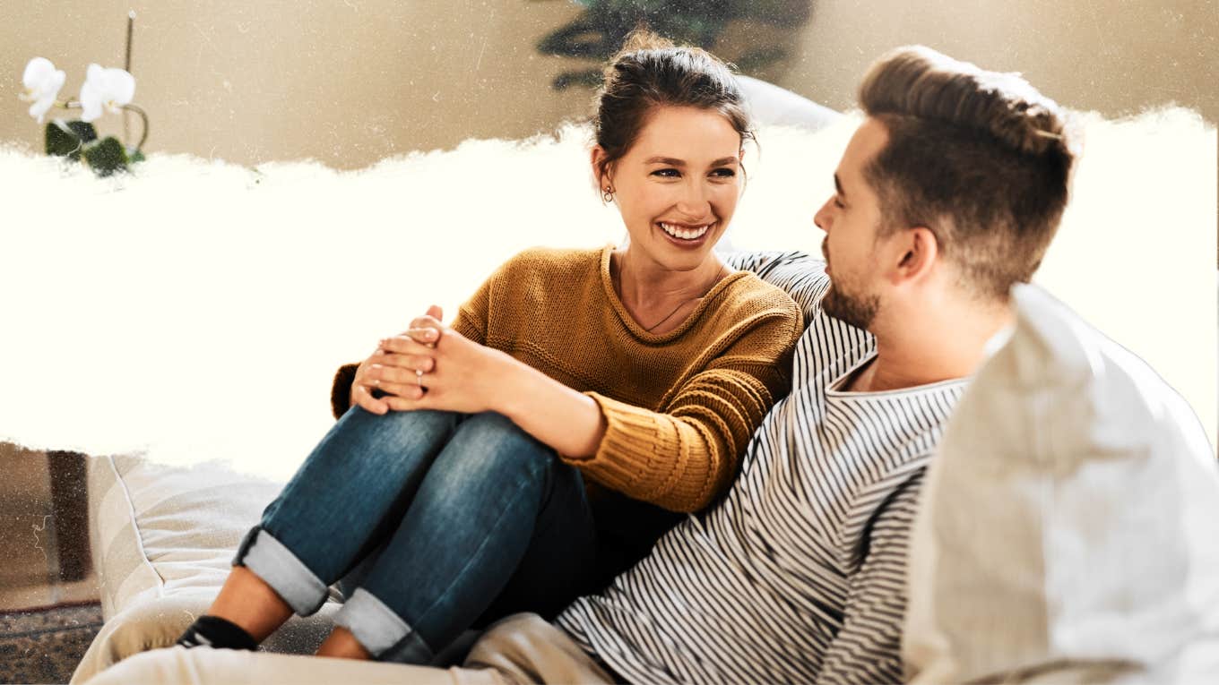 Happy couple, talking to each other on couch 