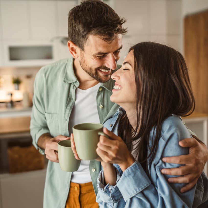 husband rubbing wife's shoulder while they have coffee